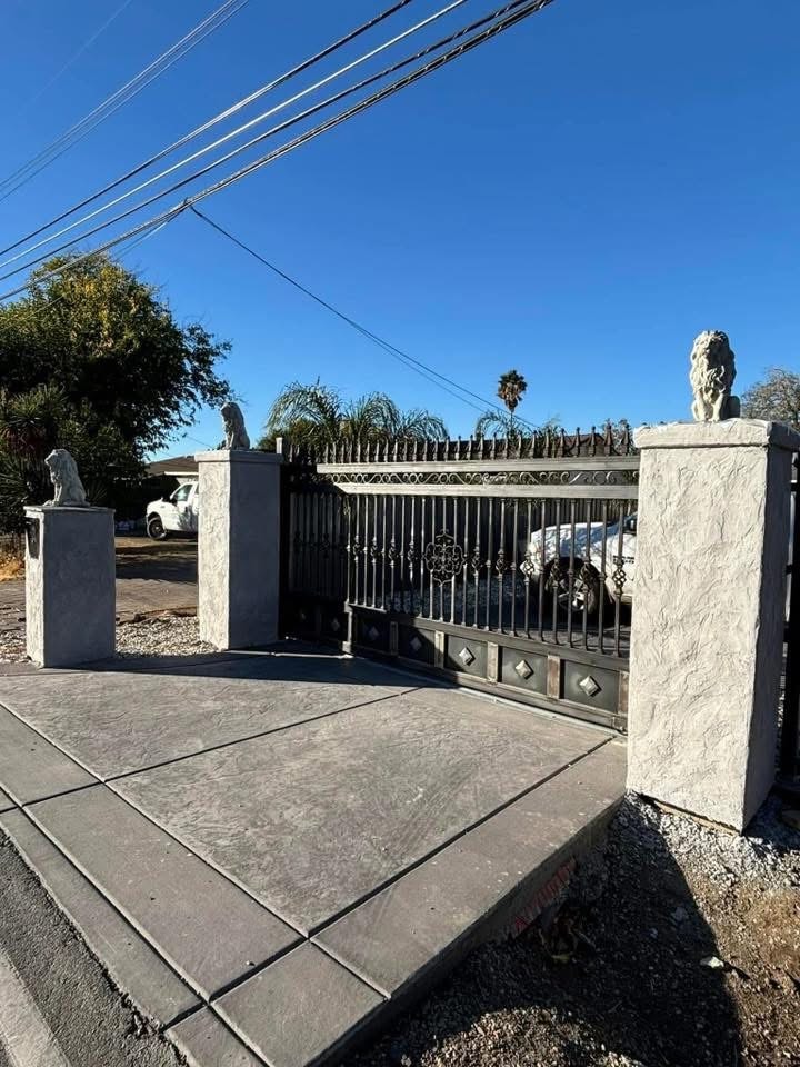 Ornamental Iron Driveway Gate with Lion Pillars